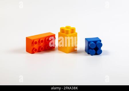 Multicolored blocks of the children's constructor lie on a white background Stock Photo