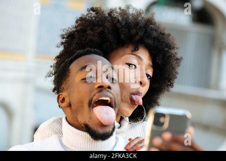 Black and funny couple taking a selfie Stock Photo