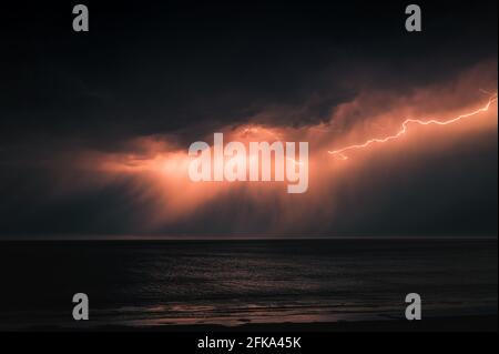 Lightning storm over the ocean Stock Photo