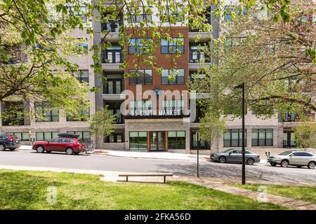 ASHEVILLE, NC, USA-25 APRIL 2021: 55 South Market, a condominium complex in downtown, on an early spring day.  Entrance framed by newly leafing trees. Stock Photo