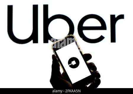 Spain. 27th Apr, 2021. In this photo illustration a Uber logo seen displayed on a smartphone screen with a Uber logo in the background. (Photo by Thiago Prudencio/SOPA Images/Sipa USA) Credit: Sipa USA/Alamy Live News Stock Photo