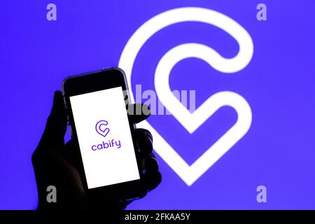 Spain. 27th Apr, 2021. In this photo illustration a Cabify logo seen displayed on a smartphone screen with a Cabify logo in the background. (Photo by Thiago Prudencio/SOPA Images/Sipa USA) Credit: Sipa USA/Alamy Live News Stock Photo