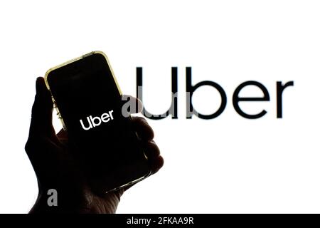 Spain. 27th Apr, 2021. In this photo illustration a Uber logo seen displayed on a smartphone screen with a Uber logo in the background. Credit: Thiago Prudencio/SOPA Images/ZUMA Wire/Alamy Live News Stock Photo