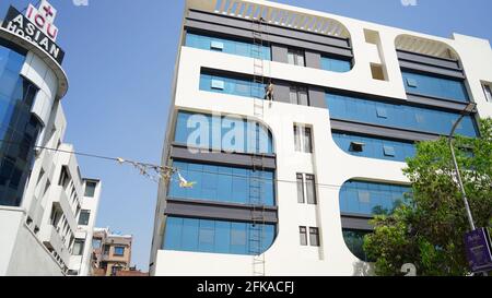 04 March 2021-Metro city, Jaipur, India. New modern Hospital and medical health centre closeup with blue glass door. Modern outpatient center closeup. Stock Photo