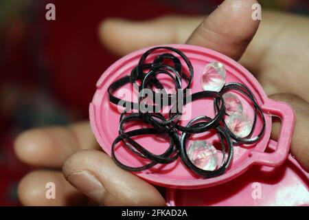 black colored rubber and diamond stock on hand Stock Photo