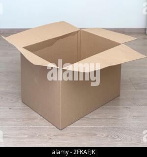 empty cardboard box on the floor in the room. moving concept Stock Photo