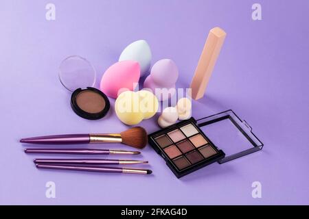 different colors of beauty blender, blush, eyeshadow and make up brushes Stock Photo