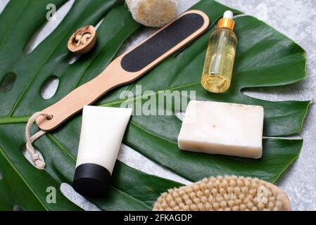 Spa composition with body care items and plants on a gray background. Top view. Stock Photo