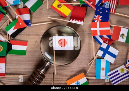 Japanese Flag. Research, economics, development and technology concept. Flags of different countries and a magnifying glass Stock Photo