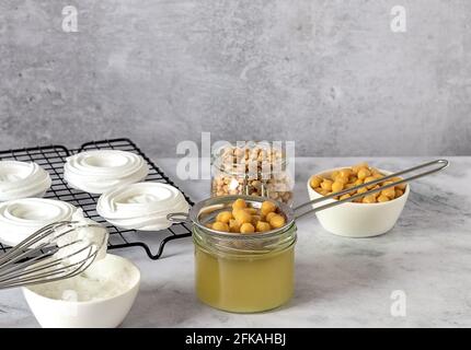 Vegan cooking concept. Meringue from canned chickpea water aquafaba. Healthy product. Eggs replacement and substitute.  Stock Photo