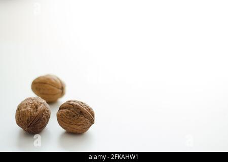 Three whole walnuts isolated on white background; autumn nuts Stock Photo