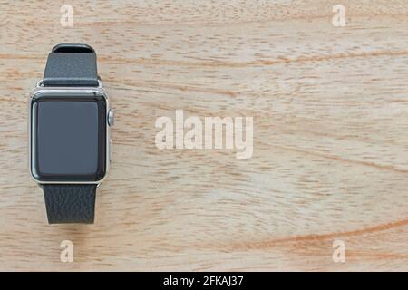 Smart watch with leather bands on wooden background with copyspace Stock Photo