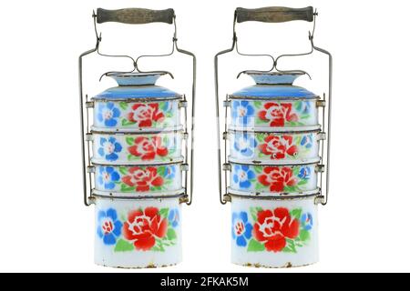 Vintage rusty metal food carrier (Tiffin carrier) in white with colorful flowers isolated on white background Stock Photo