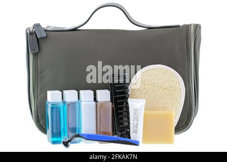 Black traveling cosmetic bag with toiletries in the front, isolated on white Stock Photo