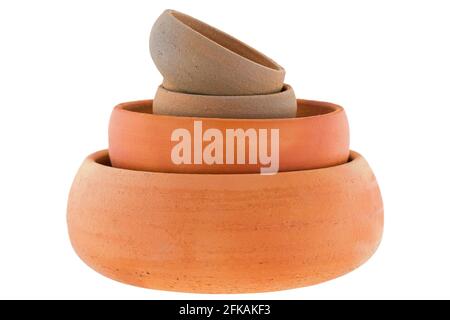 Stack of handmade round unglazed clay pots in different size isolated on white background Stock Photo