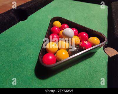 billiards, miniature playing field with balls on the playing field in green fabric Stock Photo