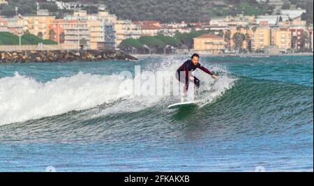 Imperia, Italy, 24-01-2021: professional surfer in training in the sea of Liguria, sports reportage Stock Photo