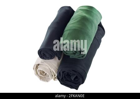Stack of rolled clothes, t-shirt, pants, black jeans isolated on white background Stock Photo