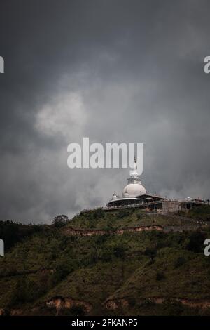 Mahamevnawa Buddhist Monastery temple in the mountain top low angle scenic landscape view. dark rainy clouds and cold atmosphere in Bandarawela, stupa Stock Photo