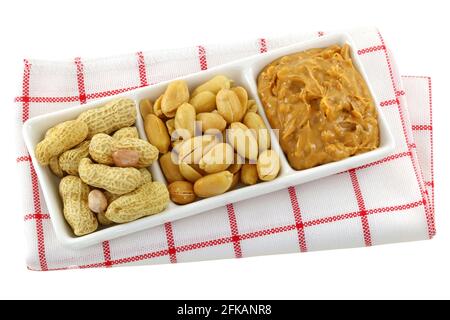 A dish of roasted groundnuts, salted peanuts and peanut butter, isolated on white Stock Photo