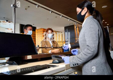 Couple paying by credit card at the reception desk Stock Photo