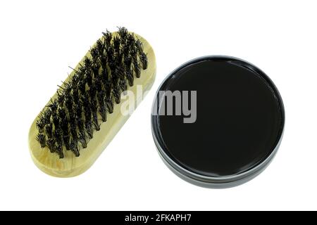 A can of shoe polish in Black color with a shoe brush isolated on white background Stock Photo