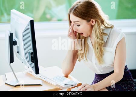 Tired woman at work Stock Photo