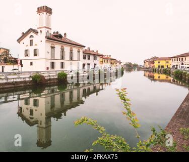 Stunning colorful village overlooking the navigable canal called Naviglio Grande, near Milan.Gaggiano,Lombardy, Italy. Stock Photo