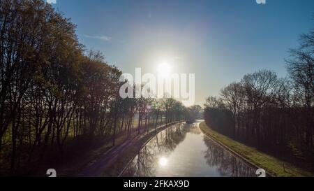 Aerial View Of An Idillic River Stream Canal With Grass Banks And Wild 