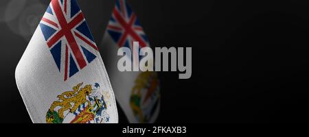 Small national flags of the British Antarctic Territory on a dark background Stock Photo