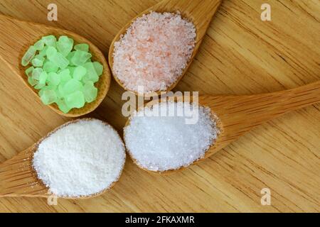 Pink Himalayan Salt, Sea Salt, Mountain Salt and Epsom Salt in a wooden spoon Stock Photo