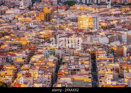 Highly dense populated city in Spain at sunset. Warm tones. High angle view. Alicante, Spain. Stock Photo