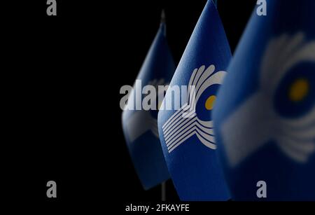 Small national flags of the CIS on a dark background Stock Photo