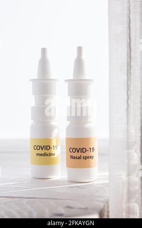 New treatment against Coronavirus COVID-19 (SARS-CoV) nasal spray and throat spray. Conceptual image of new innovative nasal spray bottles with text. Stock Photo