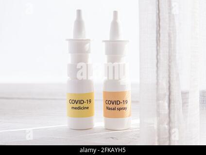 New treatment against Coronavirus COVID-19 (SARS-CoV) nasal spray and throat spray. Conceptual image of new innovative nasal spray bottles with text. Stock Photo