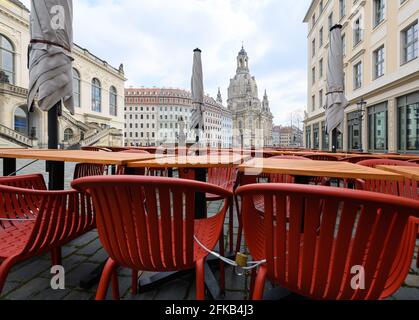30 April 2021, Saxony, Dresden: Tables and chairs are set up in front of a restaurant on the Neumarkt in front of the Frauenkirche. Photo: Robert Michael/dpa-Zentralbild/dpa Stock Photo