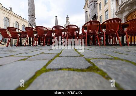 30 April 2021, Saxony, Dresden: Tables and chairs are set up in front of a restaurant on the Neumarkt in front of the Frauenkirche. Photo: Robert Michael/dpa-Zentralbild/dpa Stock Photo