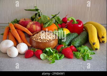 Healthy fruits and vegetables on kitchen desk Stock Photo
