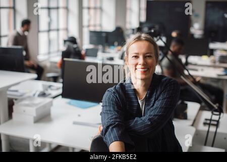 Portrait of businesswoman smiling at office Stock Photo