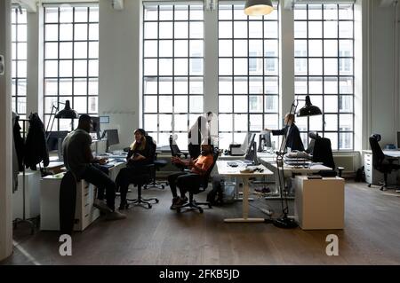 Male and female professionals discussing during meeting in office Stock Photo
