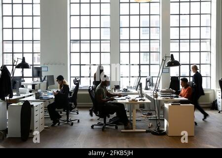 Business people working at desk in creative office Stock Photo