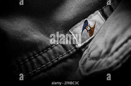 Tag on dark clothing in the form of the flag of the Eurasian Economic Union Stock Photo