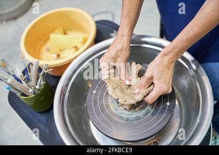 Creative hobby. Close up shot of hands of woman shaping, creating handmade clay ceramics in pottery workshop studio Stock Photo