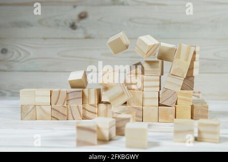 Business concept - Abstract geometric real floating wooden cube float on wood floor white background for display or montage word. Stock Photo