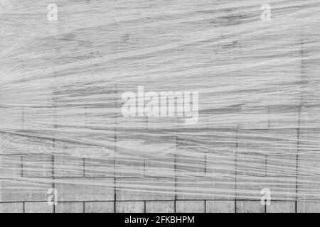 A pile of new paving stone slabs wrapped in plastic wrap background. Building tile materials at the construction site. Stock Photo