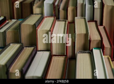 Stack of books background. many books piles. Stack of Books of Different Thickness and Color, Many Books Piles in the School Library, Pile of Old Book Stock Photo