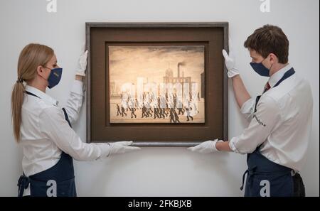 Sotheby’s, London, UK. 30 April 2021. The earliest known sports painting of Crowds Gathering for a Rugby Match in 1928 by L.S. Lowry is unveiled at Sotheby’s and will be auctioned at Sotheby’s London in summer, estimate £2,000,000-3,000,000. The work is on view for the first time in half a century. Credit: Malcolm Park/Alamy Live News. Stock Photo