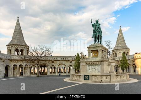 An equestrian statue of Saint Stephen with Fisherman's Bastion in the background in the Buda Castle District Stock Photo