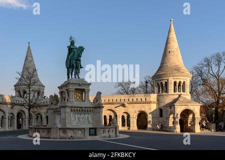 An equestrian statue of Saint Stephen with Fisherman's Bastion in the background in the Buda Castle District Stock Photo