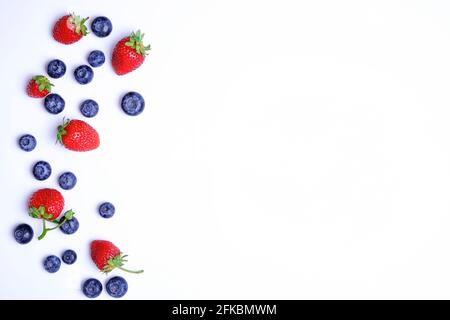 Bunch of fresh organic mixed berries, blueberry & strawberry in seamless pattern, white background. Clean eating concept. Healthy vegan snack, raw foo Stock Photo